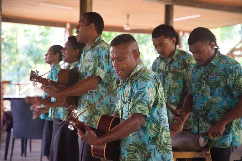 A group of people in tropical shirts playing guitars. 2