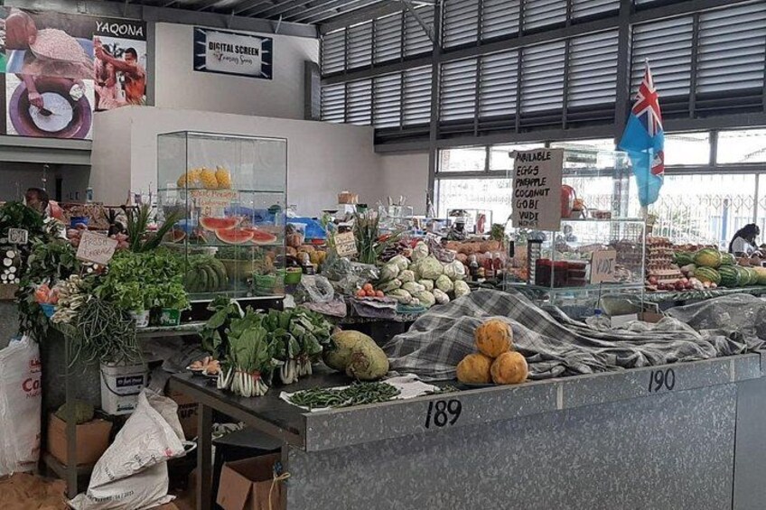 A produce section with various fruits and vegetables, including bananas, tomatoes, and leafy greens. 3