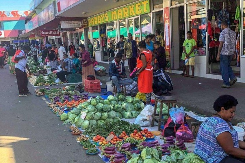 A bustling outdoor market with vendors selling fresh produce. 3