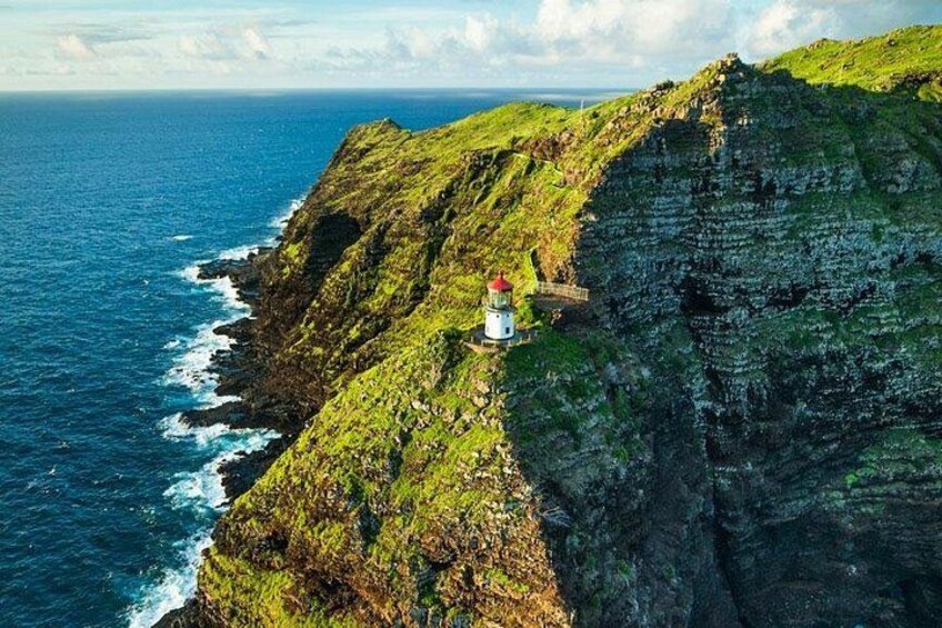 A lighthouse on a cliff overlooking the ocean. 2