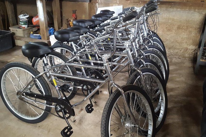 A row of bicycles parked indoors. 2