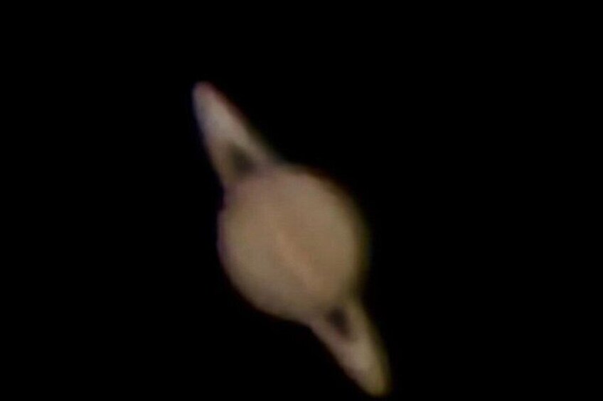 A blurry object against a dark background. 1