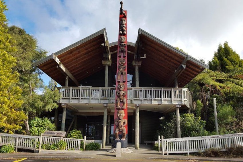 A building with a wooden structure, a balcony, and a sign that reads 'Visitor Center.' 5