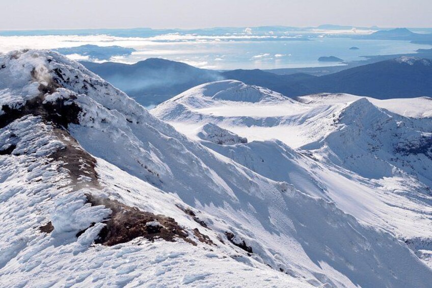 A snow-covered mountain ridge with a clear sky. 2