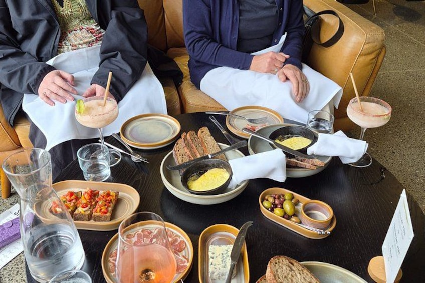 A table with food and drinks, including a salad, bread, and a drink with a straw. 3