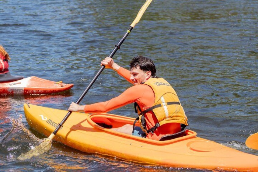 A person kayaking on a river. 5