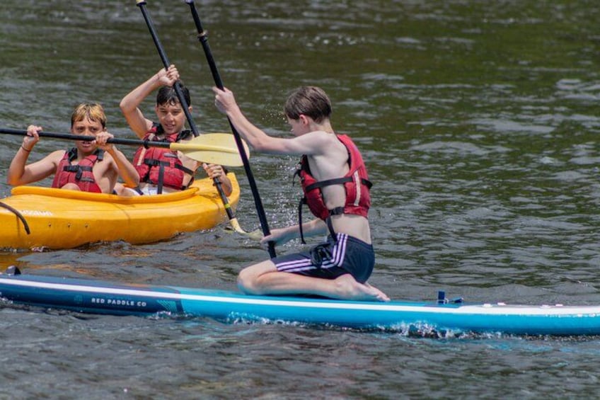 People kayaking on a calm body of water. 2