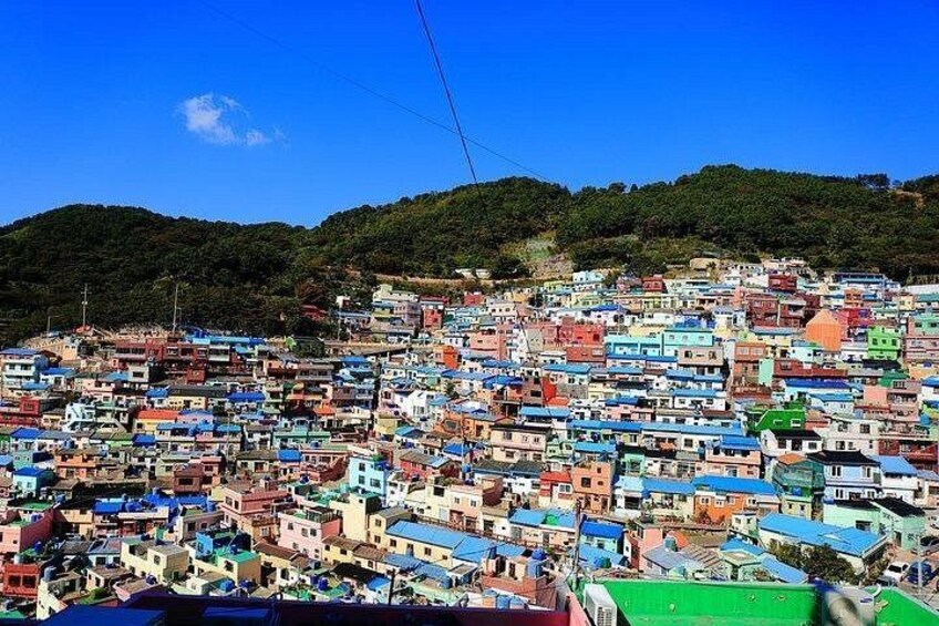 A densely packed hillside settlement with colorful buildings. 2