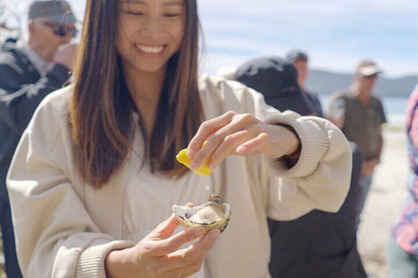 A person holding a shell with a yellow object inside it. 1