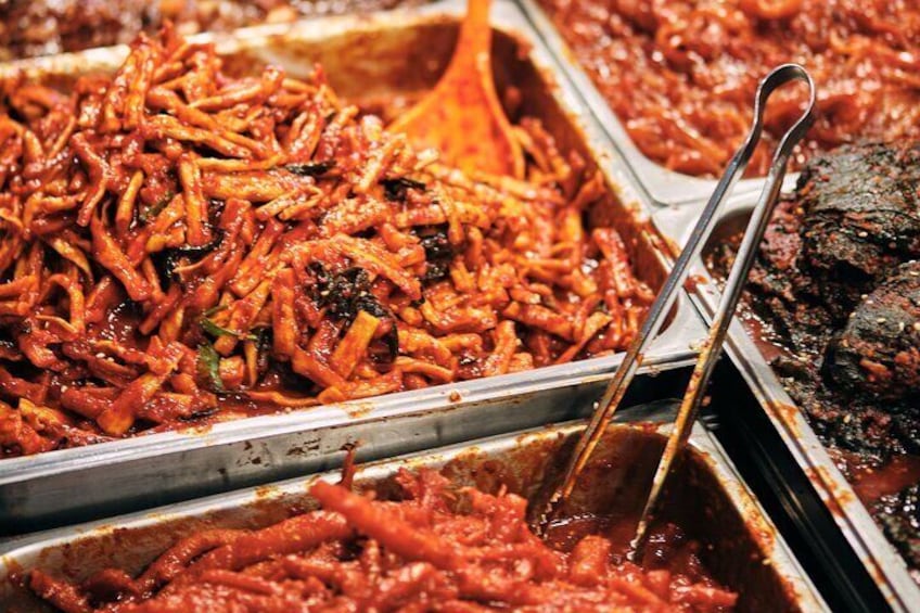 A variety of dishes, including what appears to be a meat-based dish and a pasta dish, in a buffet setting. 3