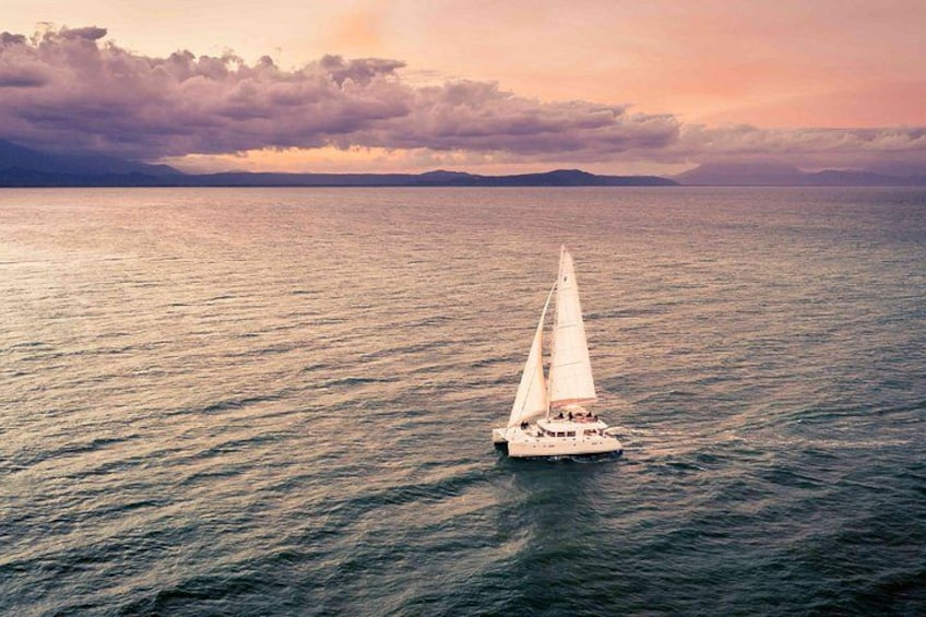A sailboat on calm waters with a sunset sky. 2