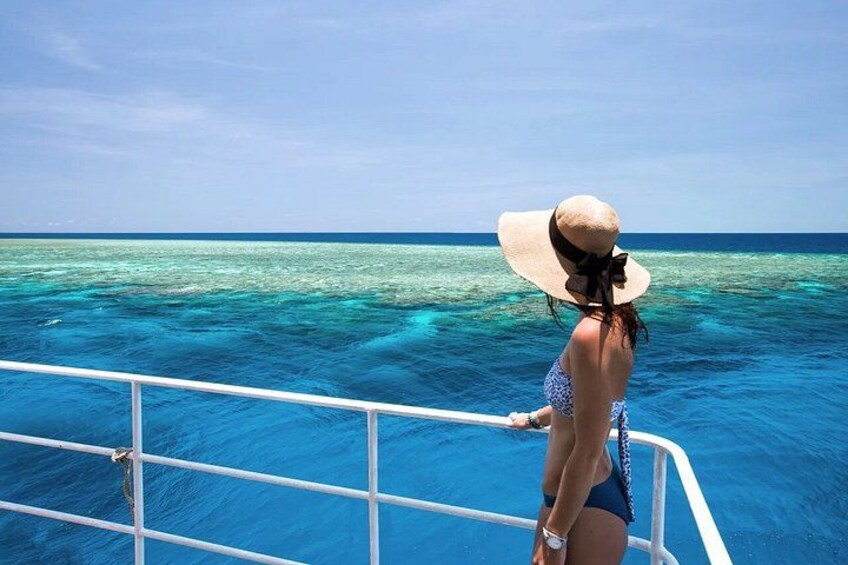 A person on a boat in clear blue waters. 5