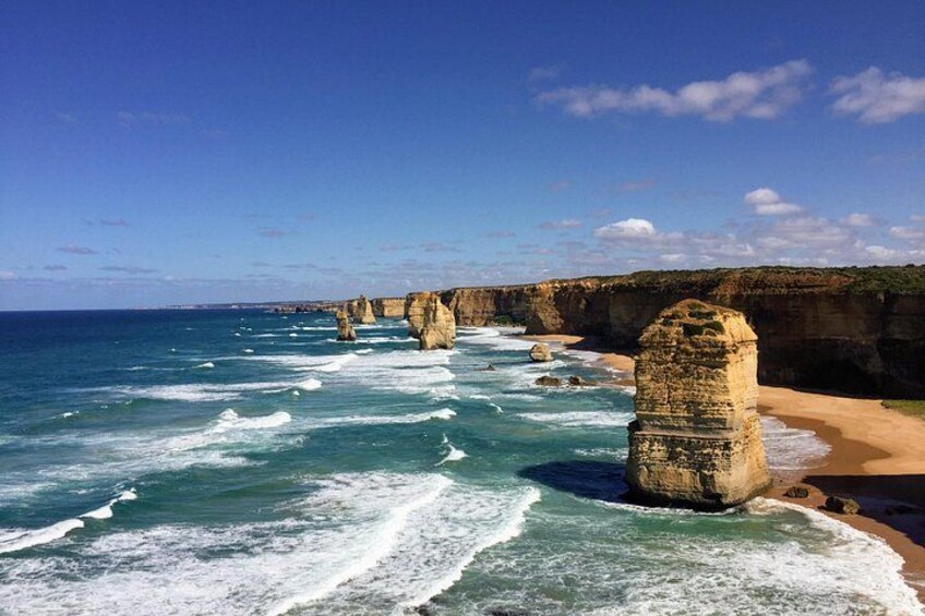 A coastal landscape with rock formations and waves. 1