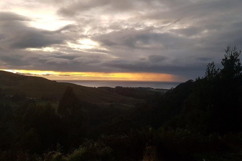 A landscape with rolling hills and a cloudy sky. 4