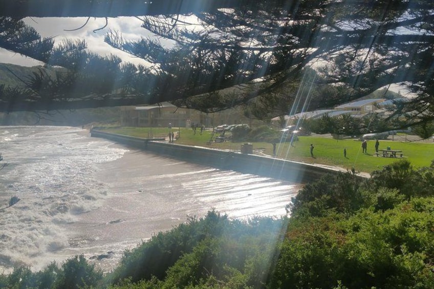 A river with a dam, a picnic area, and a mountainous landscape. 2