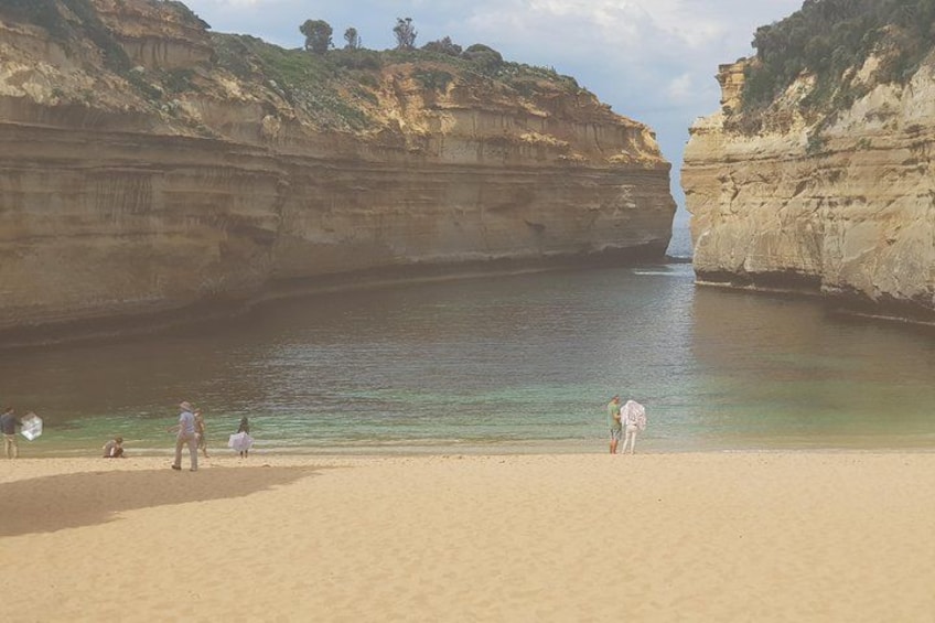 A coastal landscape with cliffs and a sandy beach. 2