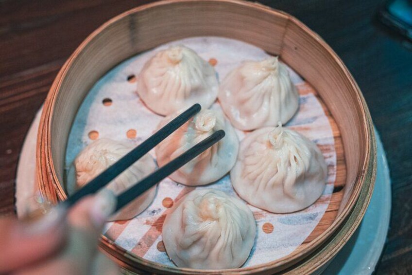 A bamboo steamer with dumplings on a cloth. 2