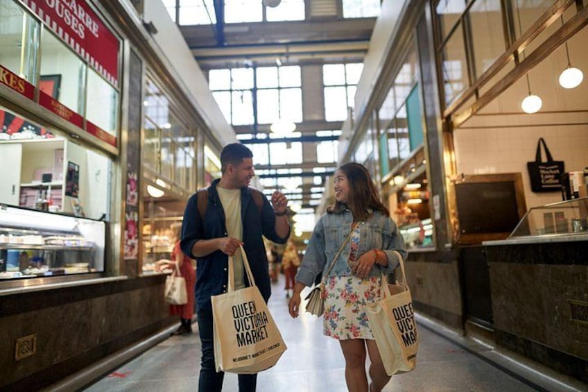 A market corridor with glass storefronts and hanging lights. 2