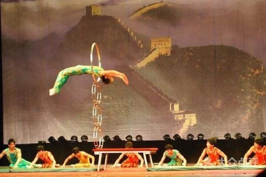 A gymnast performing on a high bar with a backdrop of a mountainous landscape. 4