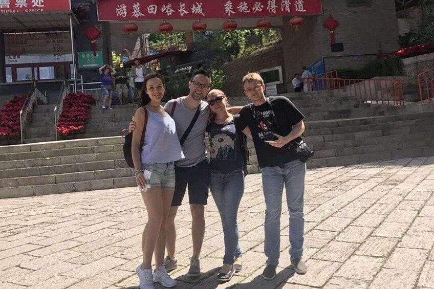 A group of people posing in front of a building with red lanterns and a sign with Chinese characters. 3