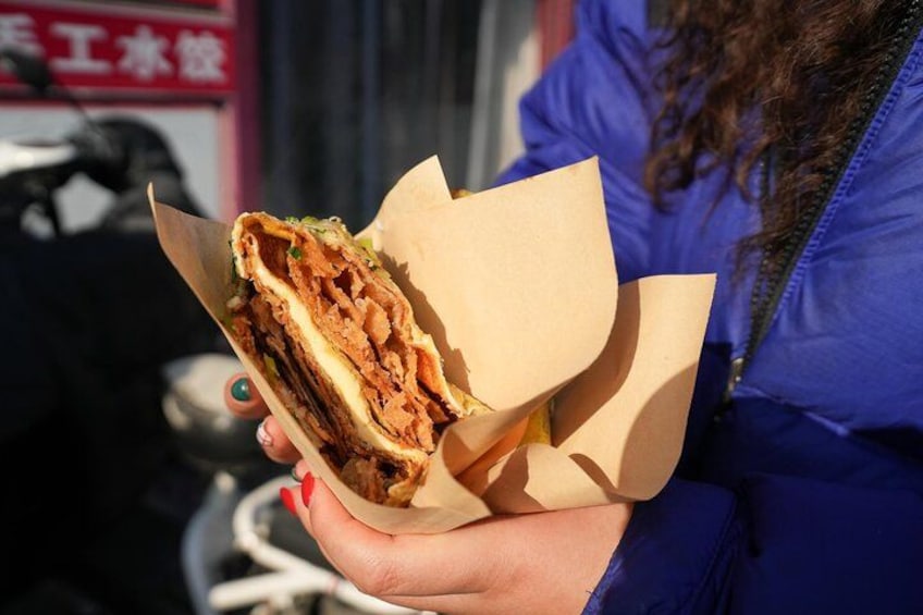 Try jianbing with a twist at this hole-in-the-wall spot, where a classic mung bean wrap meets a cheesy upgrade—blending tradition with tasty innovation. 3