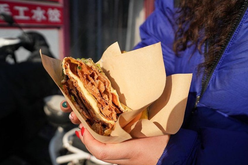Try jianbing with a twist at this hole-in-the-wall spot, where a classic mung bean wrap meets a cheesy upgrade—blending tradition with tasty innovation. 2