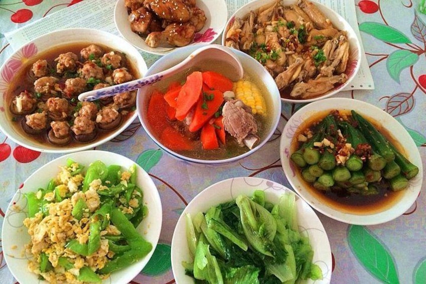 A table with various dishes including meatballs, soup, and vegetables. 2