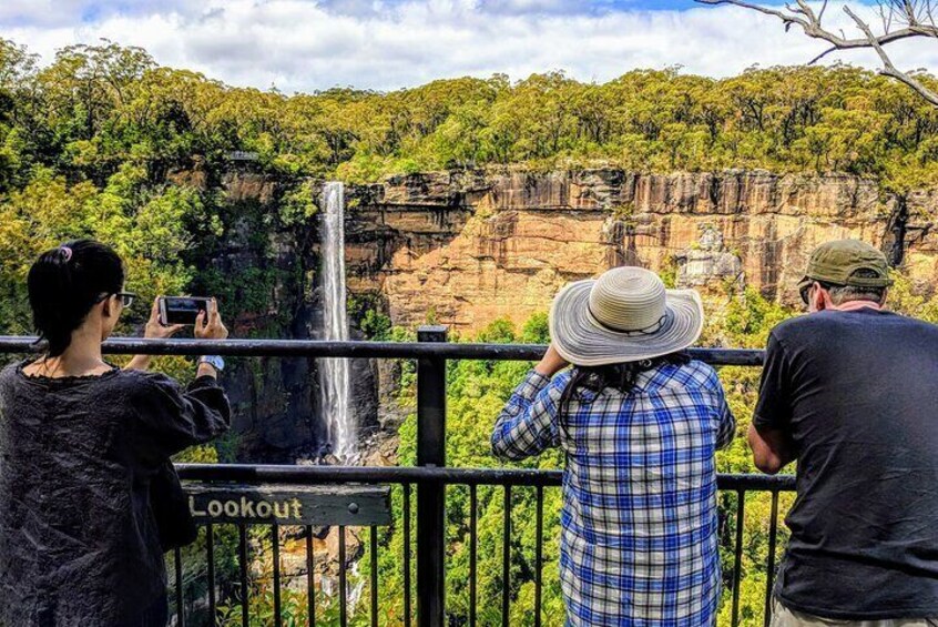 A waterfall with a lookout sign. 4