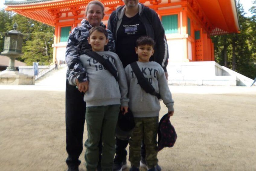 A family in front of a traditional Japanese torii gate. 5