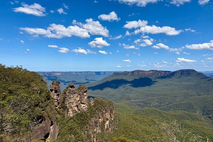 A landscape with rock formations and a clear blue sky. 5