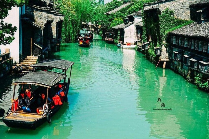 A narrow waterway with traditional buildings on either side. 2
