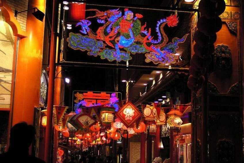 A traditional Chinese street with illuminated lanterns and a dragon decoration. 1