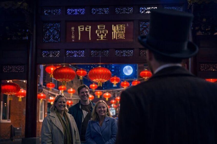 A traditional Chinese building with red lanterns and a sign with Chinese characters. 3