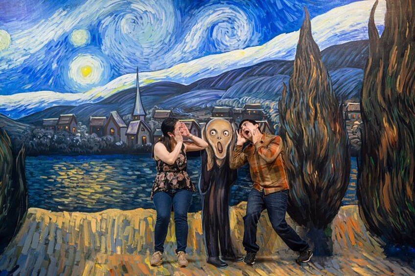A mural of a famous painting with two people in front of it. 1