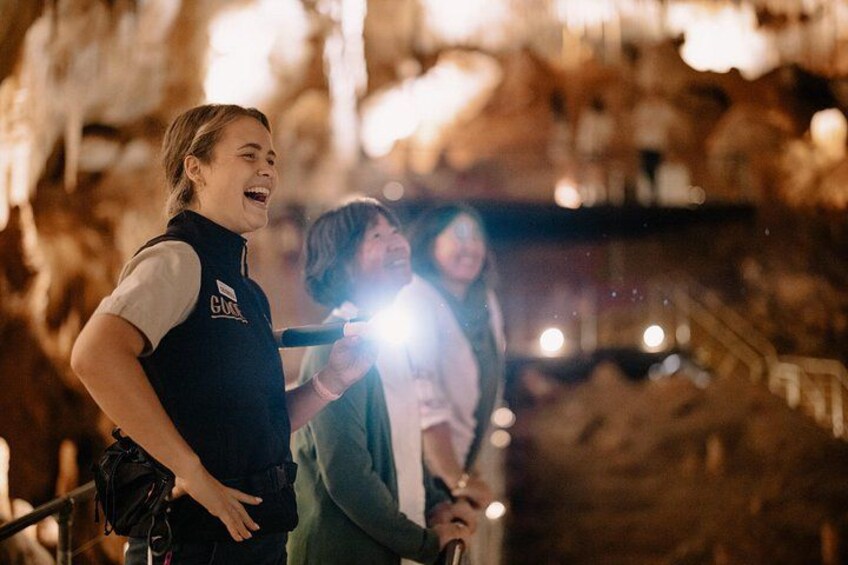 People exploring a cave with artificial lighting. 2