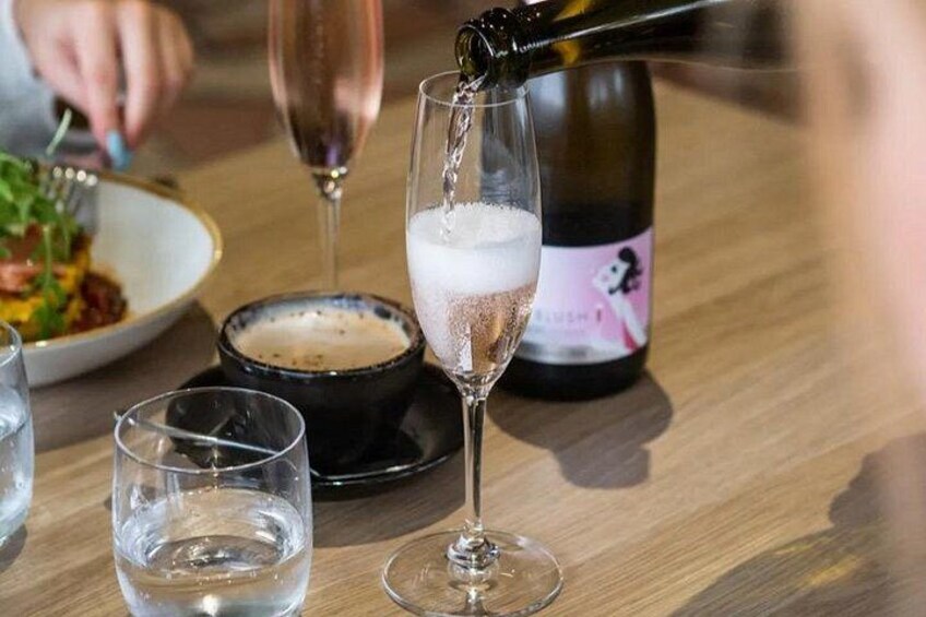 A bottle of champagne being poured into a glass. 3