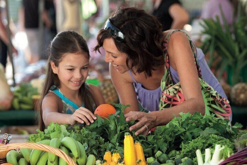 A person selecting vegetables at a market. 4