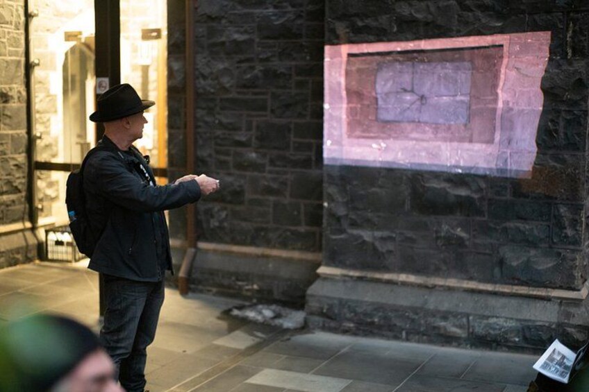 A person pointing at a map on a wall. 5