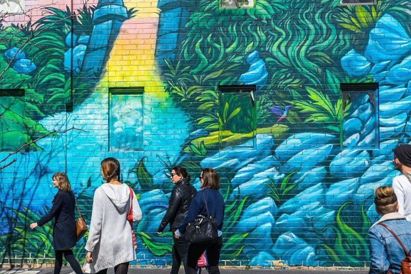 A mural with a blue and green color scheme, featuring abstract patterns and shapes. 4
