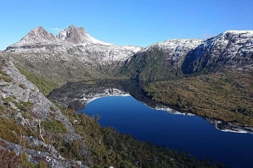 A mountainous landscape with a lake and snow-capped peaks. 2