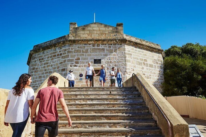 A stone building with a staircase leading up to it. 3