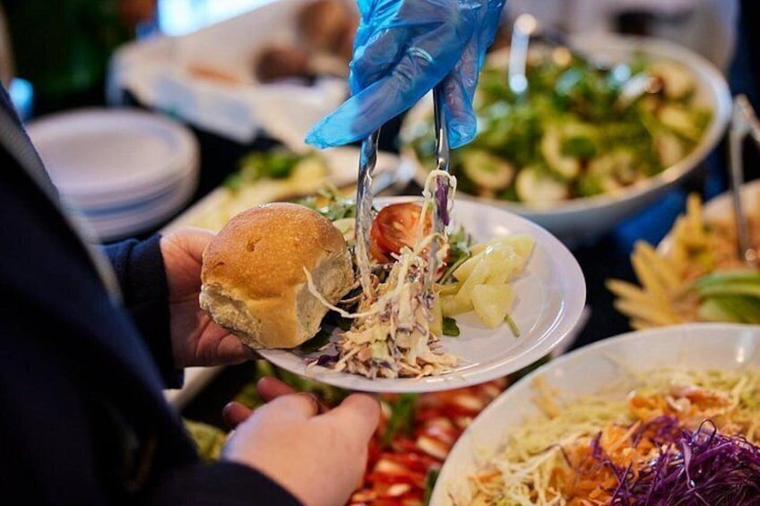 A person serving food at a buffet. 3