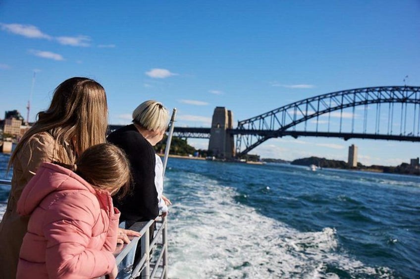 A family on a boat with the Sydney Harbour Bridge in the background. 2