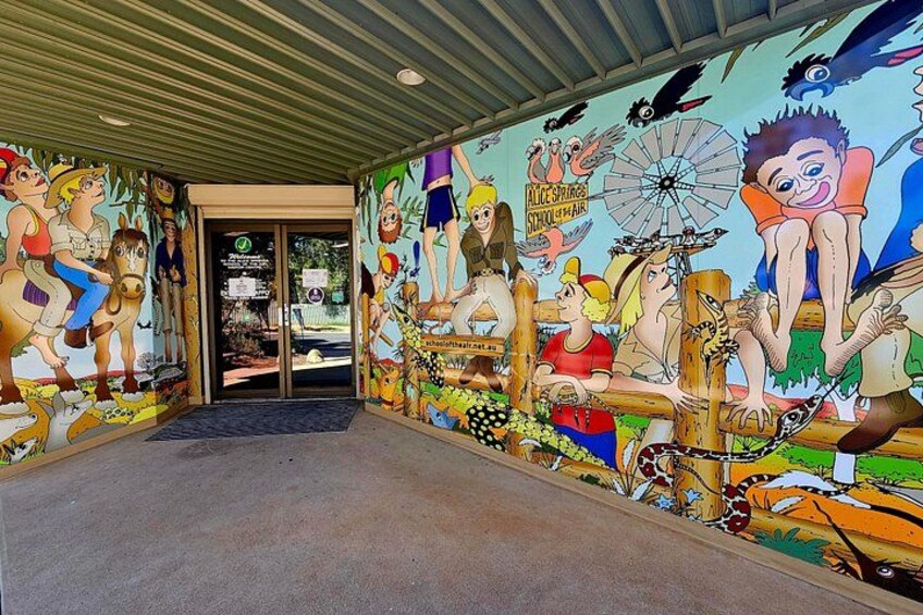 A mural with various characters and a Ferris wheel. 3