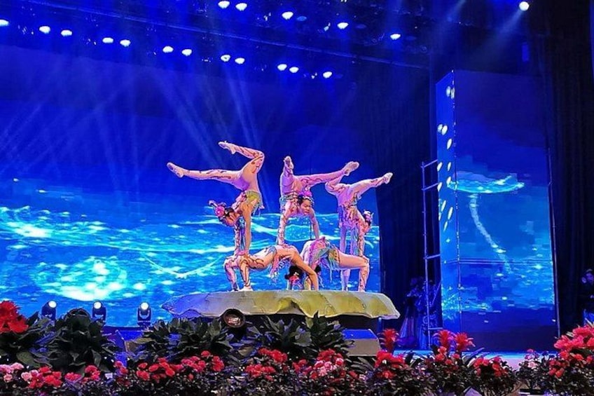 A stage with dancers performing a synchronized routine. 1