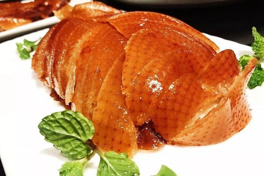 A glazed fruit dish with a glossy finish, garnished with mint leaves. 2