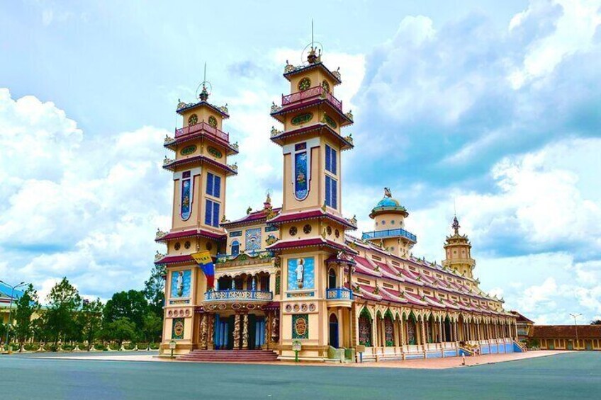 A large, ornate building with multiple towers and domes, featuring intricate architectural details and a prominent entrance. 1