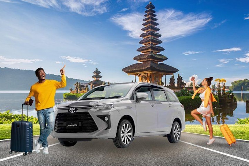 A white Toyota SUV parked on a road with a person holding a suitcase and another person with a suitcase. 5