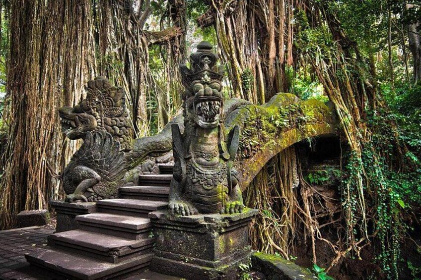 A stone staircase with a lion and elephant statue, surrounded by dense jungle vegetation. 3