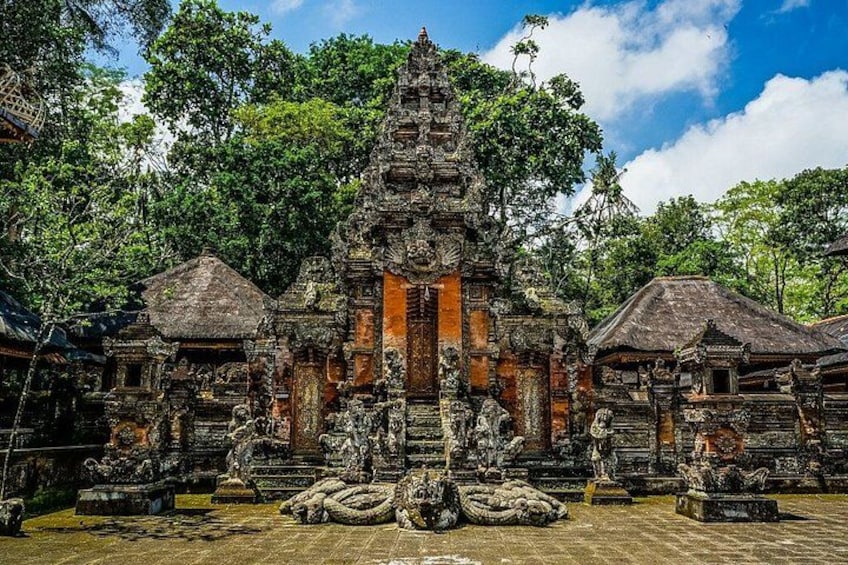 A temple with intricate carvings, a central doorway, and statues. 2